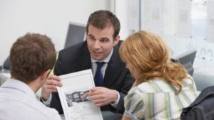 real estate agent showing a listing to prospective buyer